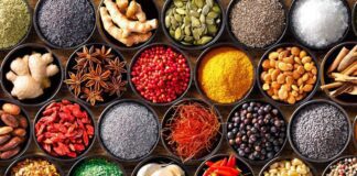 Colourful background from various herbs and spices for cooking in bowls