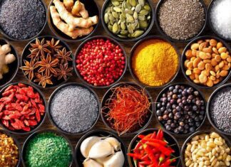 Colourful background from various herbs and spices for cooking in bowls