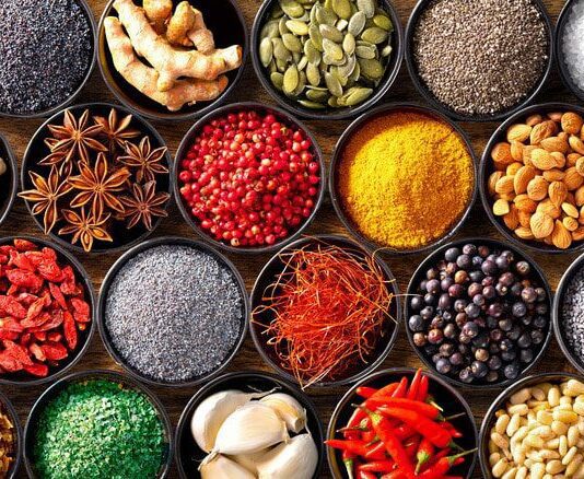 Colourful background from various herbs and spices for cooking in bowls